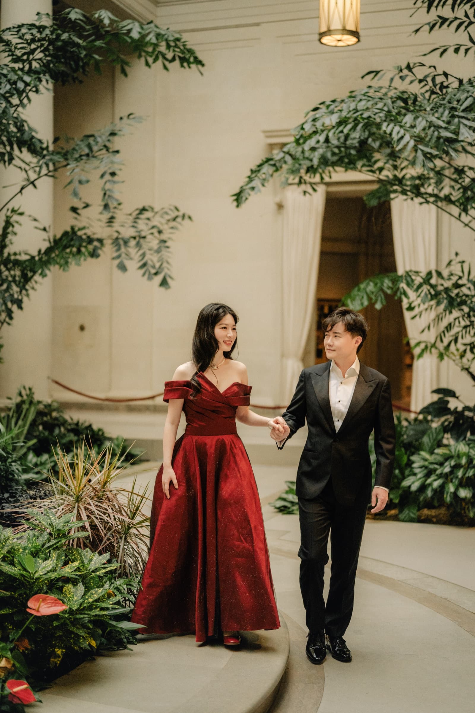 Couple walking through a garden courtyard